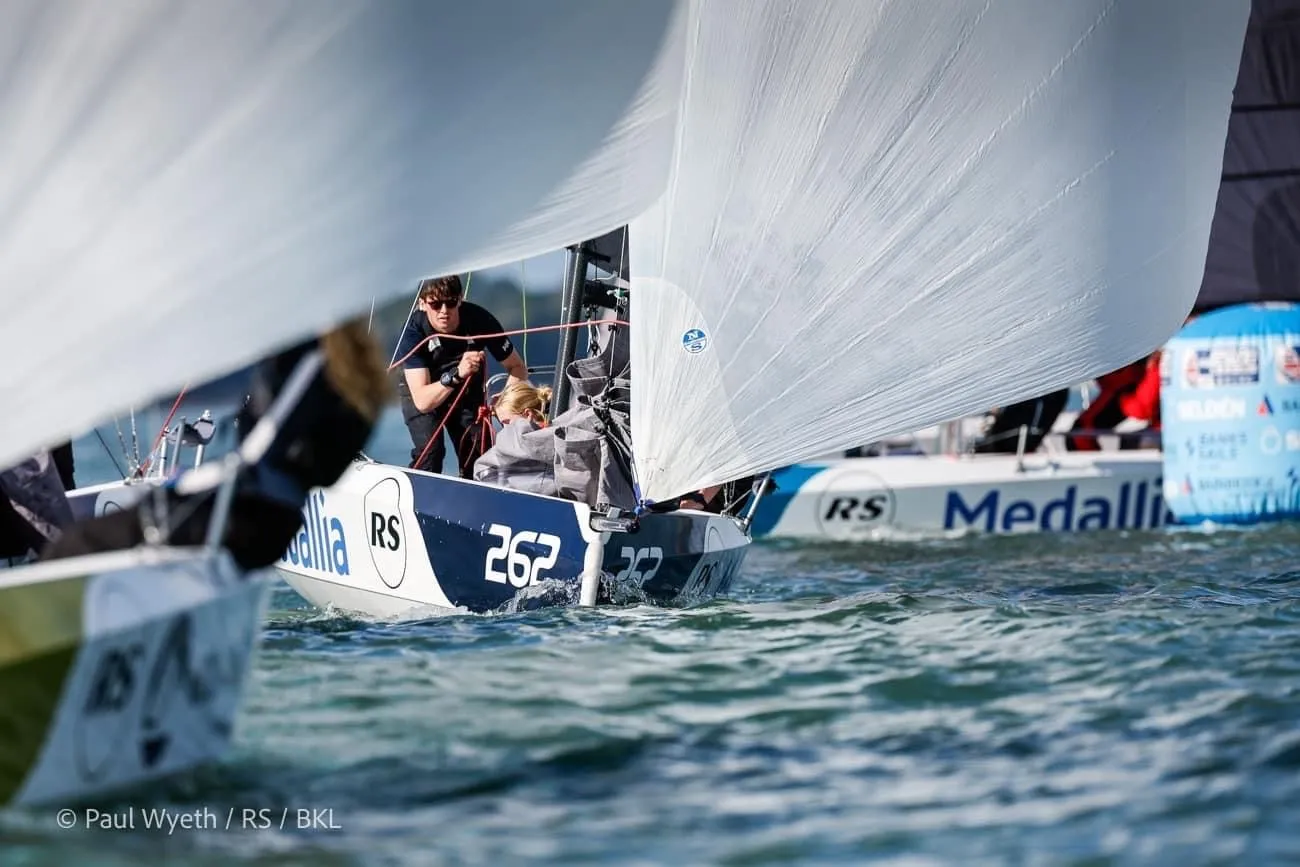 Sailboats with numbers 262 and 2622 competing in a race on the water on a sunny day.