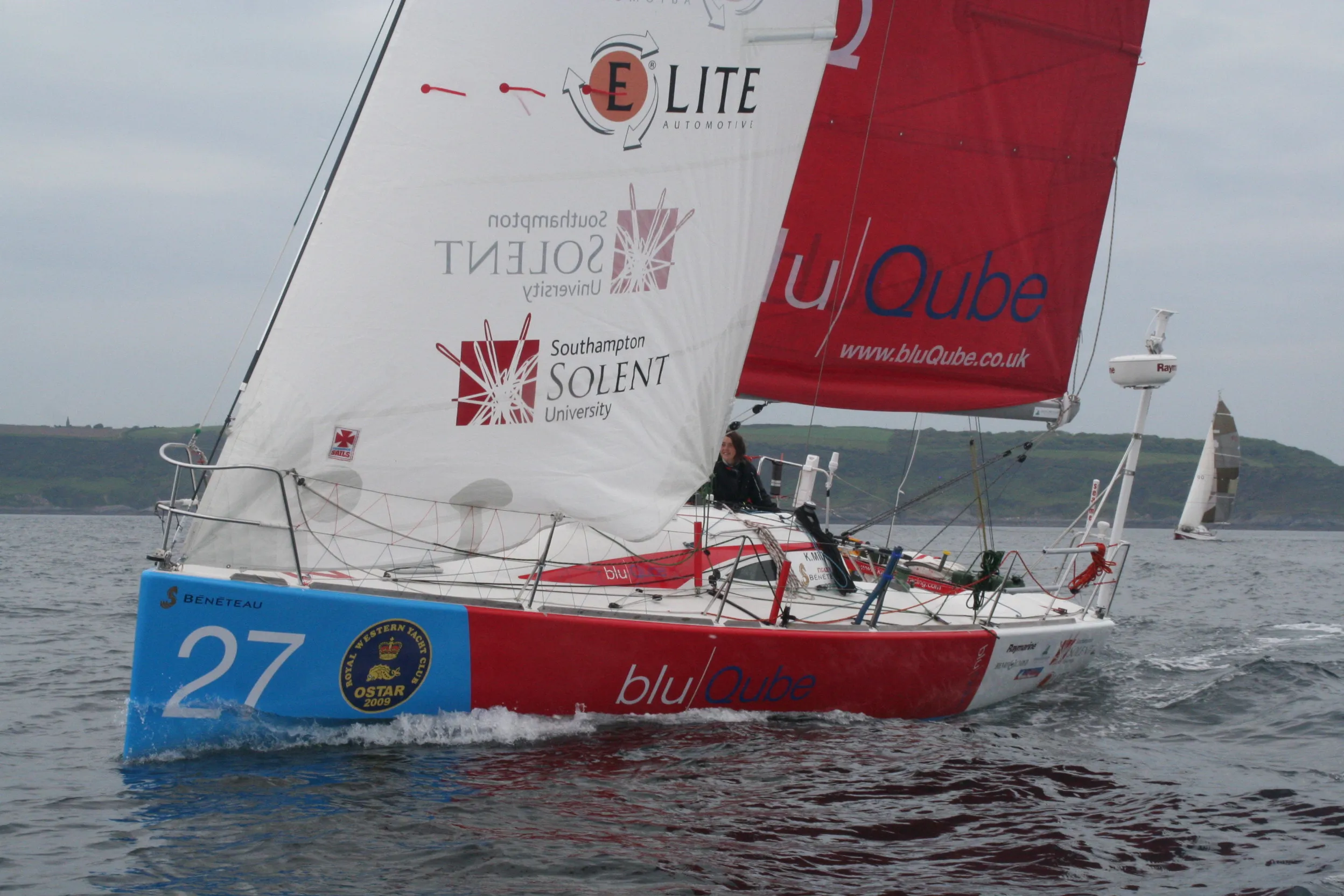 A red and white sailboat labeled 